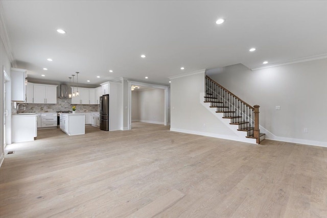 3408 Eastern Ave, Rochester Hills, MI 48307 - unfurnished living room featuring crown molding, recessed lighting, stairs, baseboards, and a sink