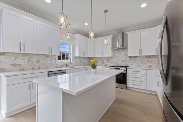 3408 Eastern Ave, Rochester Hills, MI 48307 - kitchen with stainless steel appliances, wall chimney range hood, a sink, white cabinetry, and recessed lighting