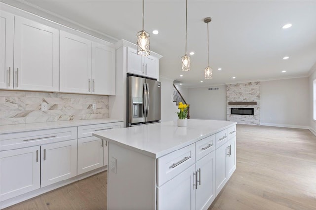 3408 Eastern Ave, Rochester Hills, MI 48307 - kitchen featuring stainless steel fridge, ornamental molding, tasteful backsplash, white cabinetry, and a kitchen island