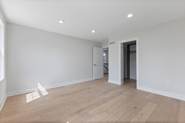 3408 Eastern Ave, Rochester Hills, MI 48307 - unfurnished bedroom with light wood finished floors, a spacious closet, baseboards, recessed lighting, and a closet
