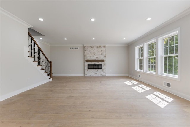 3408 Eastern Ave, Rochester Hills, MI 48307 - unfurnished living room with crown molding, light wood finished floors, baseboards, stairway, and a large fireplace