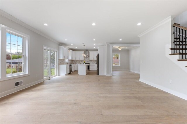 3408 Eastern Ave, Rochester Hills, MI 48307 - unfurnished living room featuring healthy amount of natural light, ornamental molding, stairs, light wood-style floors, and recessed lighting