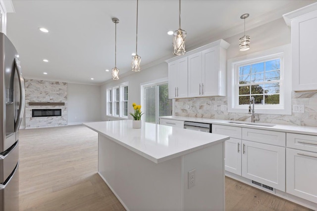3408 Eastern Ave, Rochester Hills, MI 48307 - kitchen with stainless steel fridge with ice dispenser, plenty of natural light, tasteful backsplash, crown molding, and recessed lighting