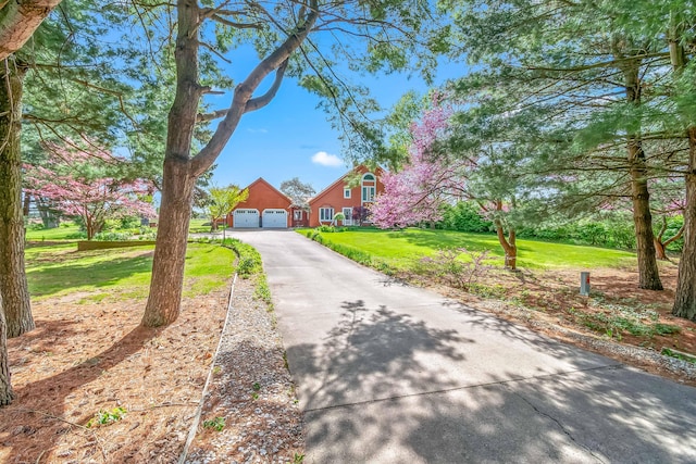 view of front of property with driveway, a front lawn, and an attached garage