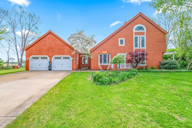 view of front of house with driveway, a front yard, and an attached garage