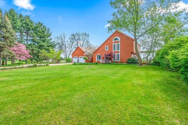 view of grassy yard with a garage