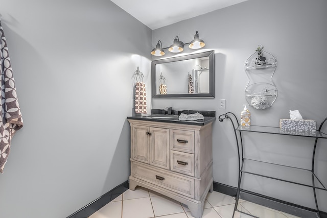 bathroom featuring vanity, tile patterned flooring, and baseboards