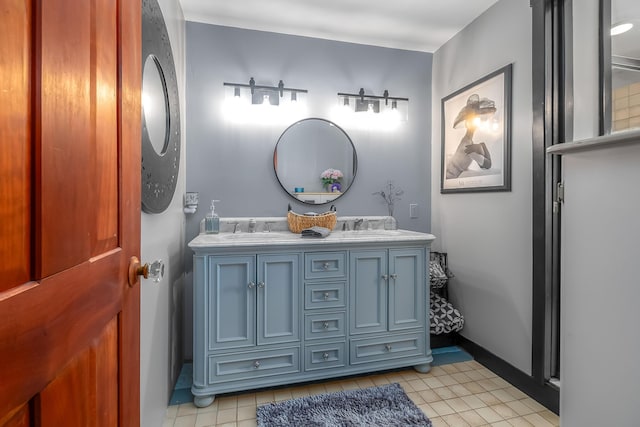 bathroom featuring tile patterned floors, double vanity, and baseboards