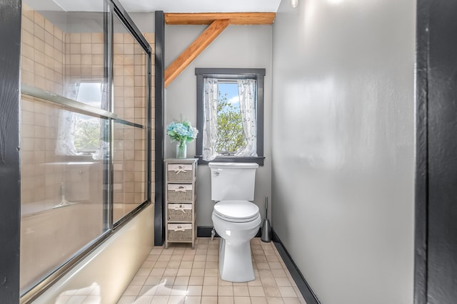 full bath featuring shower / bath combination with glass door, toilet, tile patterned flooring, and baseboards