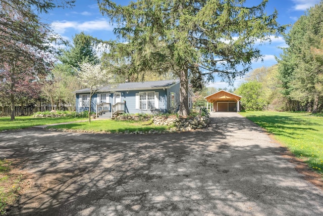 4953 Clintonville Rd, Clarkston, MI 48346 - view of front of home featuring asphalt driveway, an outbuilding, a front yard, and a detached carport