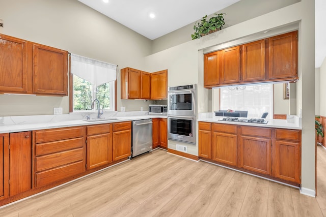 4953 Clintonville Rd, Clarkston, MI 48346 - kitchen with appliances with stainless steel finishes, a sink, brown cabinets, light countertops, and recessed lighting