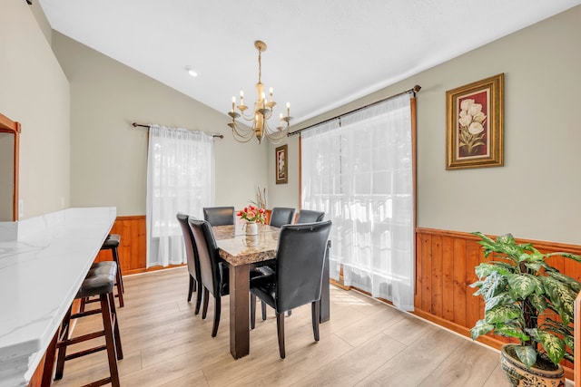 4953 Clintonville Rd, Clarkston, MI 48346 - dining area with wainscoting, a chandelier, lofted ceiling, light wood-type flooring, and wood walls