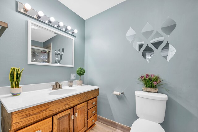 4953 Clintonville Rd, Clarkston, MI 48346 - bathroom featuring toilet, vanity, wood finished floors, a shower, and baseboards