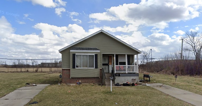 bungalow-style home with covered porch, a front lawn, and brick siding