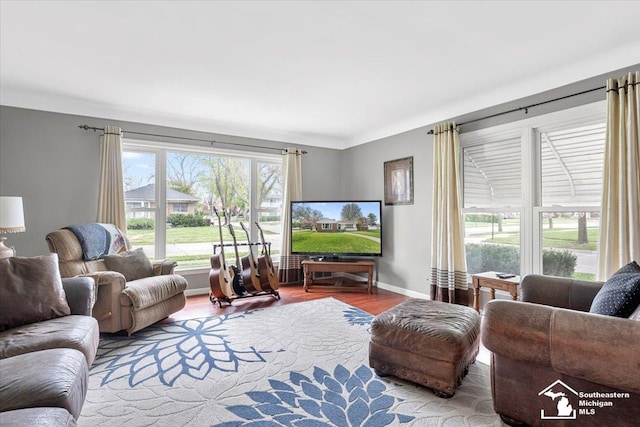 living area with wood finished floors and baseboards