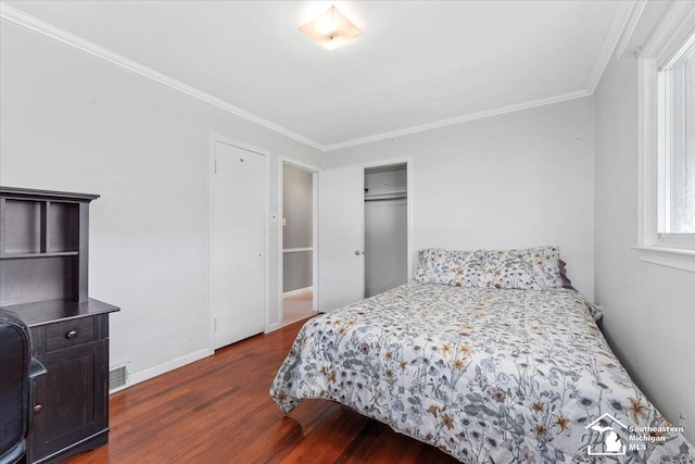bedroom featuring dark wood finished floors, ornamental molding, and baseboards