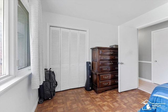 bedroom with a closet and baseboards