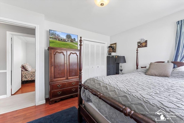 bedroom with dark wood-type flooring and a closet