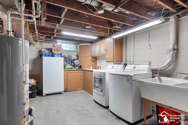 laundry area with water heater, separate washer and dryer, cabinet space, and concrete block wall