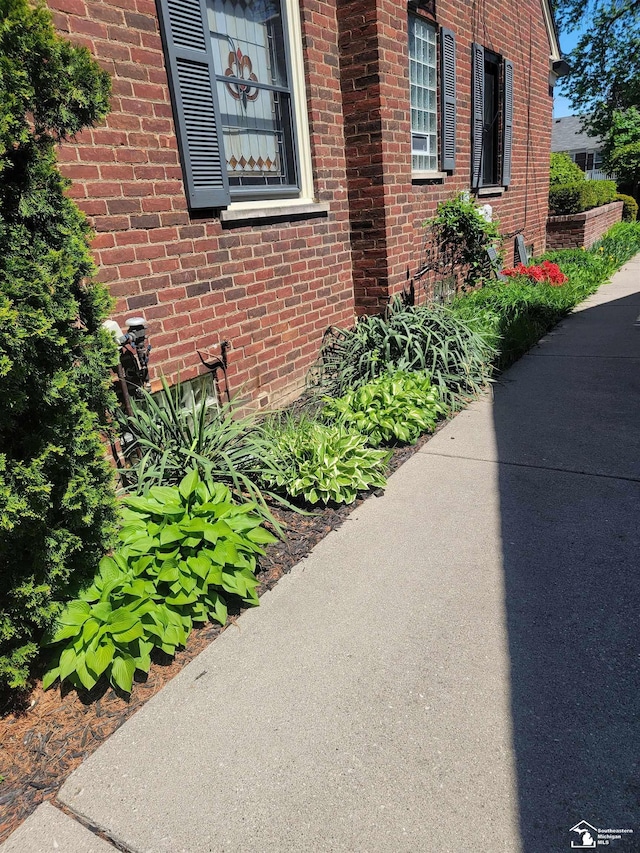 view of side of property featuring brick siding