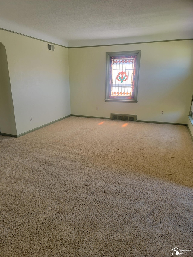 carpeted spare room with baseboards
