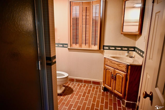 330 Devonshire St, Dearborn, MI 48124 - bathroom featuring vanity, a shower with shower door, wallpapered walls, and brick patterned flooring