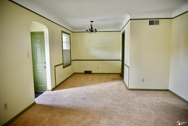 330 Devonshire St, Dearborn, MI 48124 - carpeted empty room featuring arched walkways, a chandelier, and crown molding
