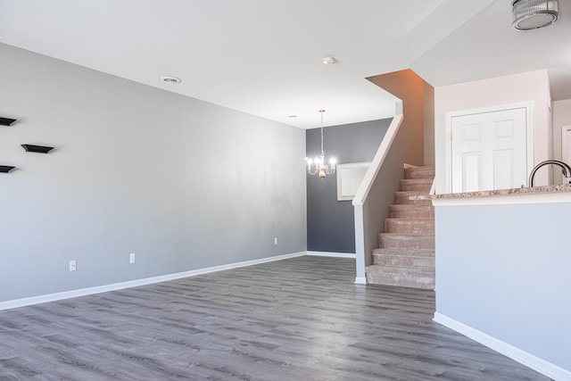 3050 Cloverly Ln, Ann Arbor, MI 48108 - unfurnished living room with a chandelier, wood finished floors, stairs, baseboards, and a sink