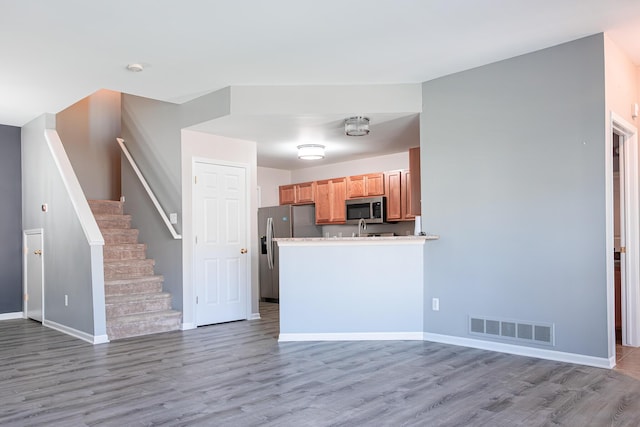 3050 Cloverly Ln, Ann Arbor, MI 48108 - kitchen with appliances with stainless steel finishes, light wood-type flooring, and baseboards