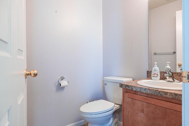 3050 Cloverly Ln, Ann Arbor, MI 48108 - bathroom featuring vanity, toilet, and baseboards