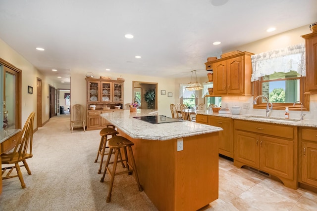 9695 36th St S, Scotts, MI 49088 - kitchen featuring a sink, black electric cooktop, a center island, recessed lighting, and a breakfast bar