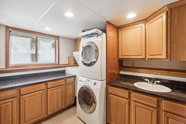 1975 Oldtown Ave, West Bloomfield, MI 48324 - washroom featuring estacked washer and dryer, light tile patterned floors, recessed lighting, and cabinet space