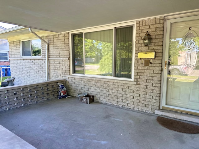 property entrance featuring brick siding