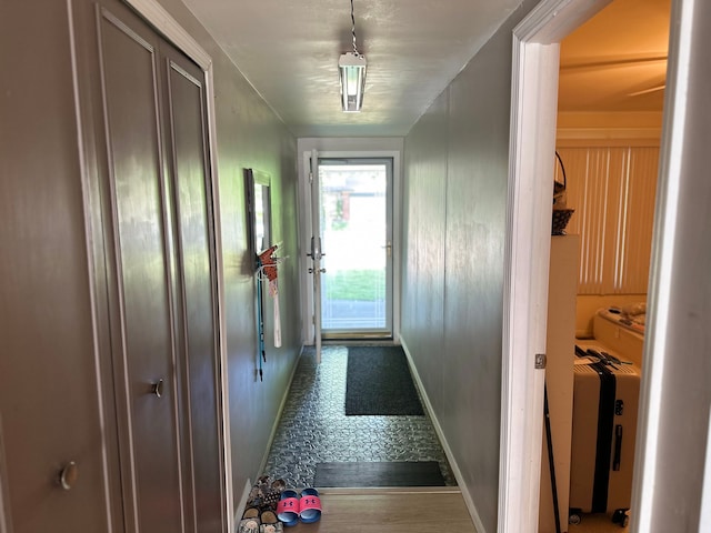 doorway to outside featuring baseboards