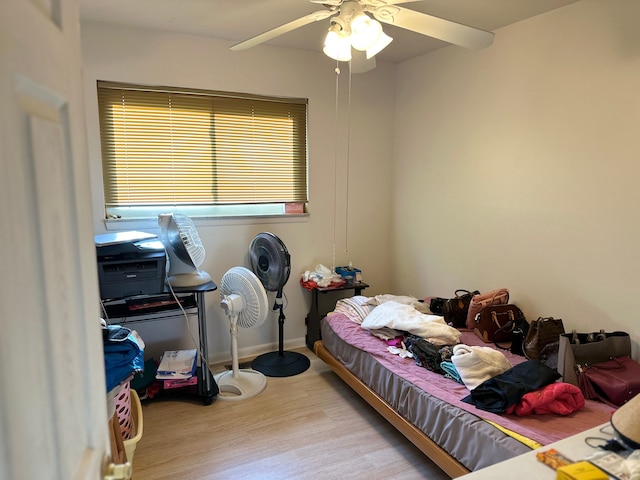 bedroom featuring wood finished floors and a ceiling fan