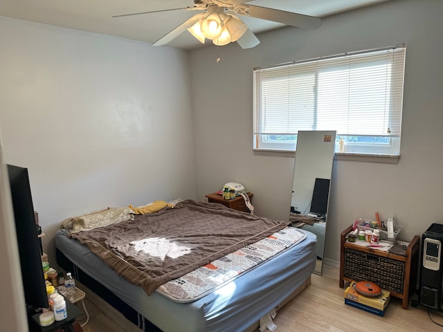 bedroom with light wood finished floors and ceiling fan