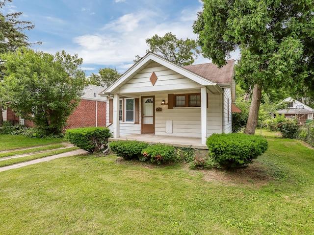 bungalow-style house featuring covered porch and a shingled roof