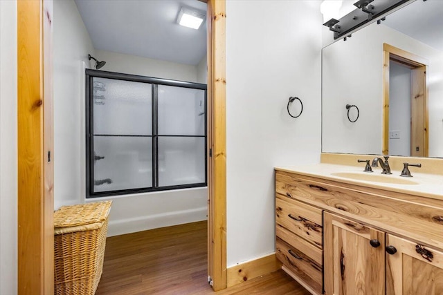 80220 Linden Hills St, Covert, MI 49043 - full bathroom featuring vanity, combined bath / shower with glass door, wood finished floors, and baseboards