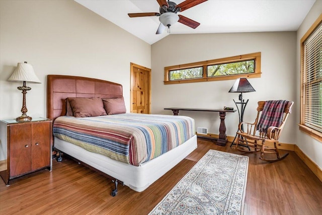 80220 Linden Hills St, Covert, MI 49043 - bedroom with multiple windows, vaulted ceiling, wood finished floors, baseboards, and ceiling fan