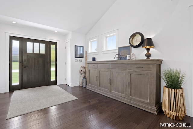 entrance foyer with recessed lighting, dark wood finished floors, high vaulted ceiling, and baseboards