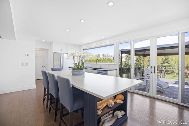 dining area featuring dark wood finished floors, recessed lighting, baseboards, and french doors
