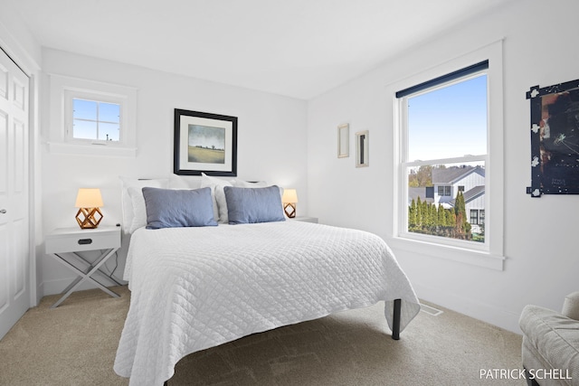 carpeted bedroom with baseboards