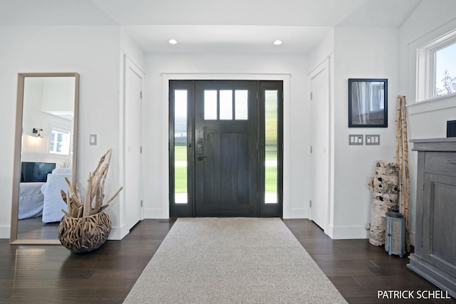 entryway with dark wood-style flooring, baseboards, and recessed lighting