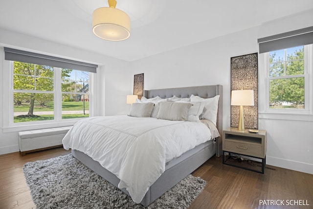 bedroom featuring baseboards and wood finished floors