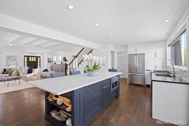 kitchen with appliances with stainless steel finishes, a sink, white cabinets, open shelves, and recessed lighting