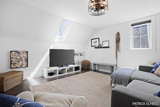 living room with wood finished floors, a skylight, healthy amount of natural light, and baseboards
