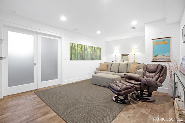 living room with wood finished floors, recessed lighting, and baseboards