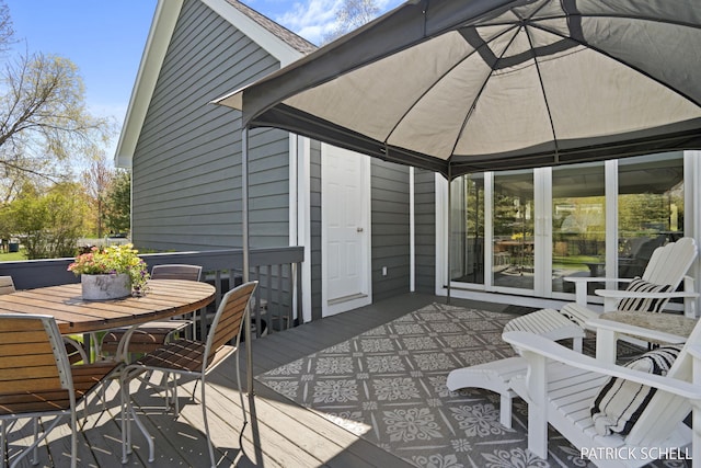 view of patio / terrace with a deck and outdoor dining space