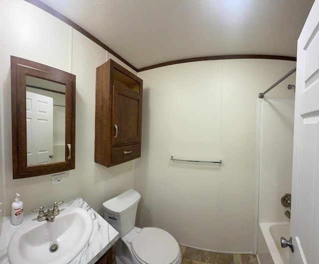 full bath with shower / washtub combination, toilet, vanity, a textured ceiling, and crown molding