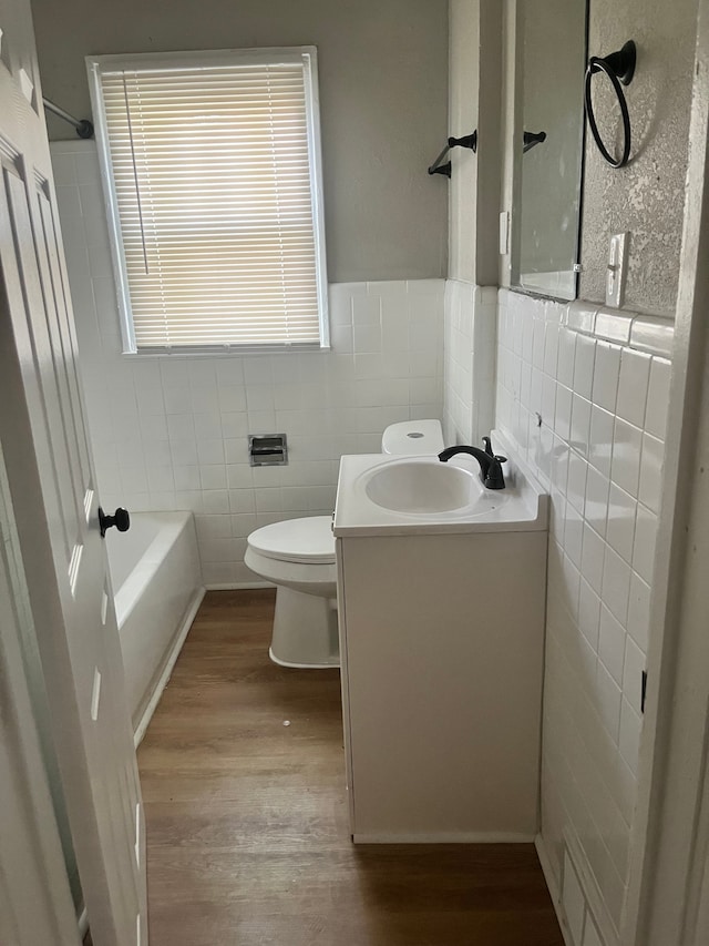 27305 Norfolk St, Inkster, MI 48141 - bathroom with tile walls, wood finished floors, toilet, vanity, and shower / tub combination